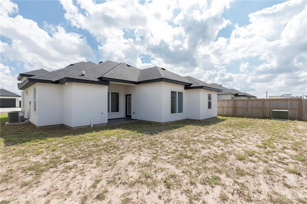 915 Pecan Street Alton, TX 78573 - Photo 18 of 22 a view of a house with a yard