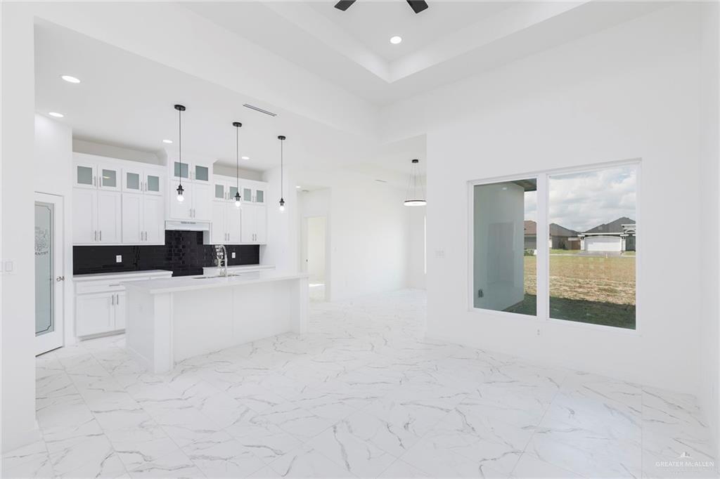 915 Pecan Street Alton, TX 78573 - Photo 3 of 22 a view of kitchen with stainless steel appliances kitchen island a sink a stove and cabinets