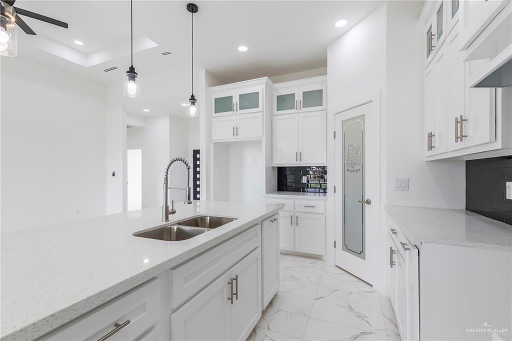 915 Pecan Street Alton, TX 78573 - Photo 6 of 22 a kitchen with white cabinets and sink