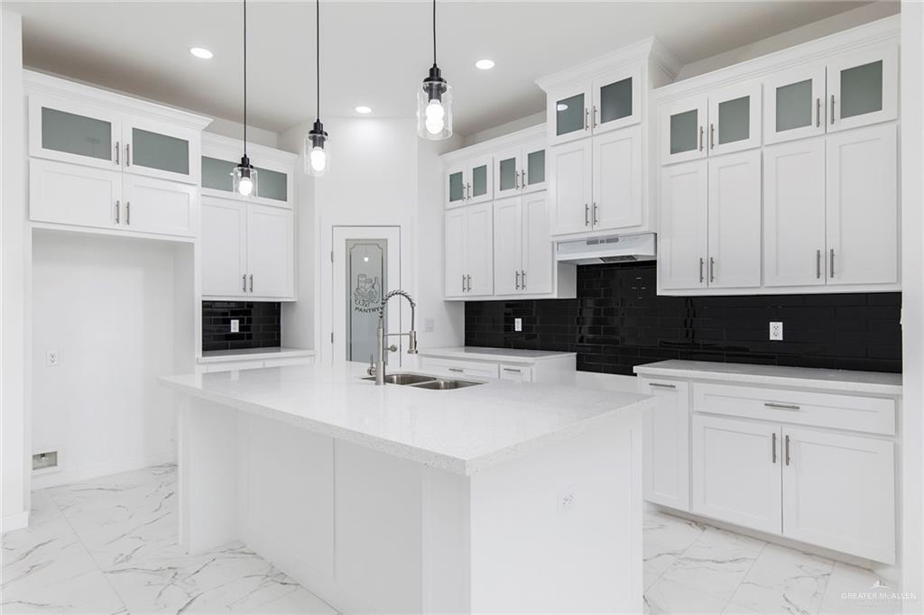 915 Pecan Street Alton, TX 78573 - Photo 7 of 22 a kitchen with stainless steel appliances granite countertop a sink a stove and a refrigerator