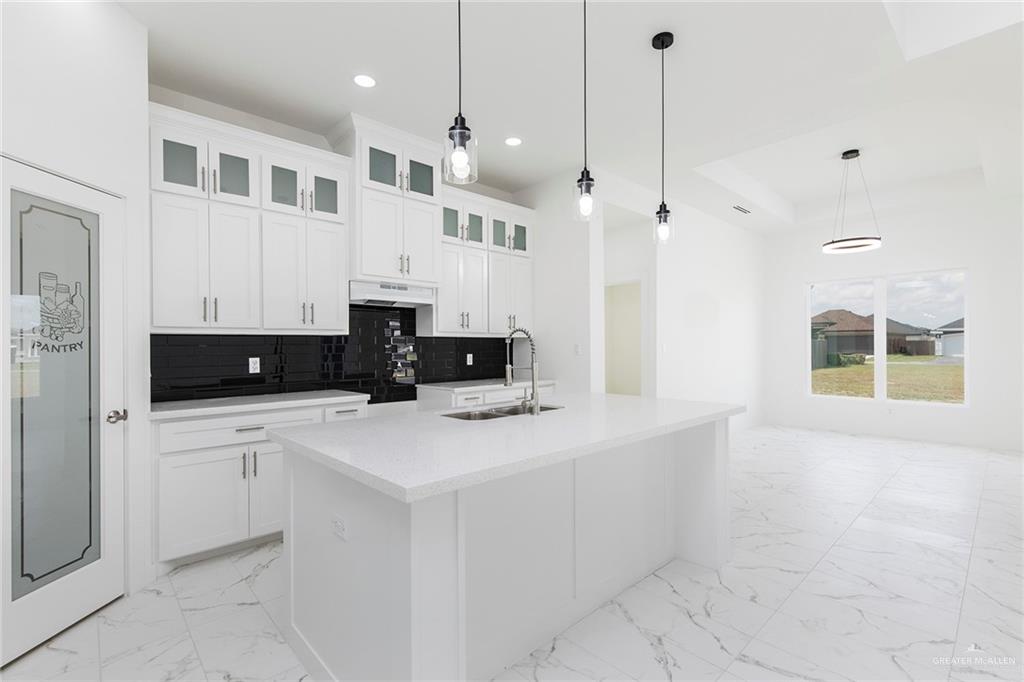 915 Pecan Street Alton, TX 78573 - Photo 8 of 22 a kitchen with stainless steel appliances a stove a sink a refrigerator a white table and chairs