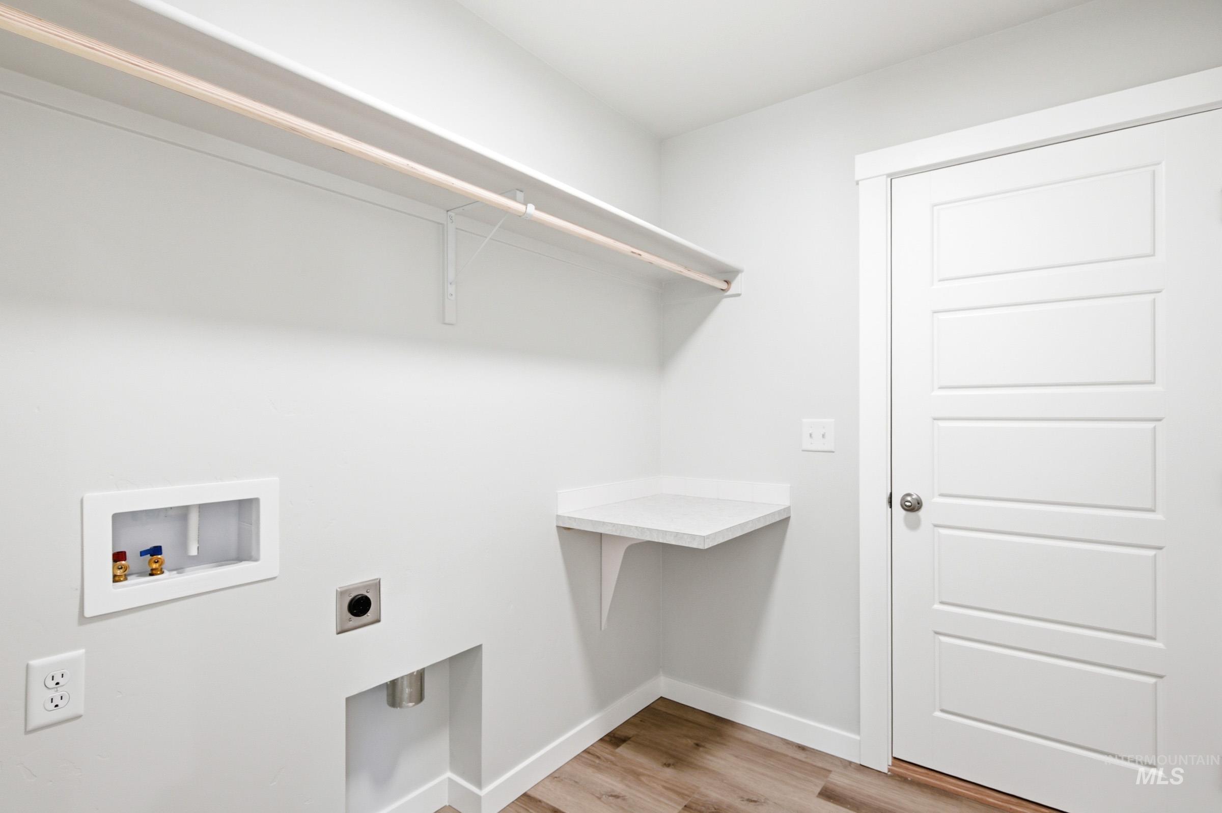 12817 Decatur Street Nampa, ID 83651 - Photo 14 of 19 Laundry area featuring wood-finish flooring and a neutral color palette