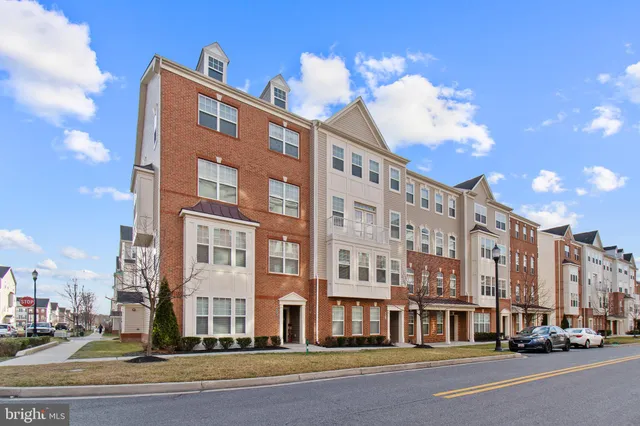 a view of a brick house with potted plants