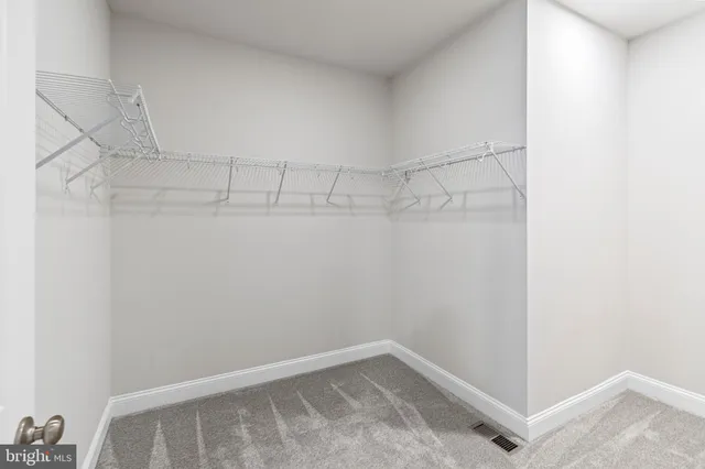 a view of a hallway with wooden shelves