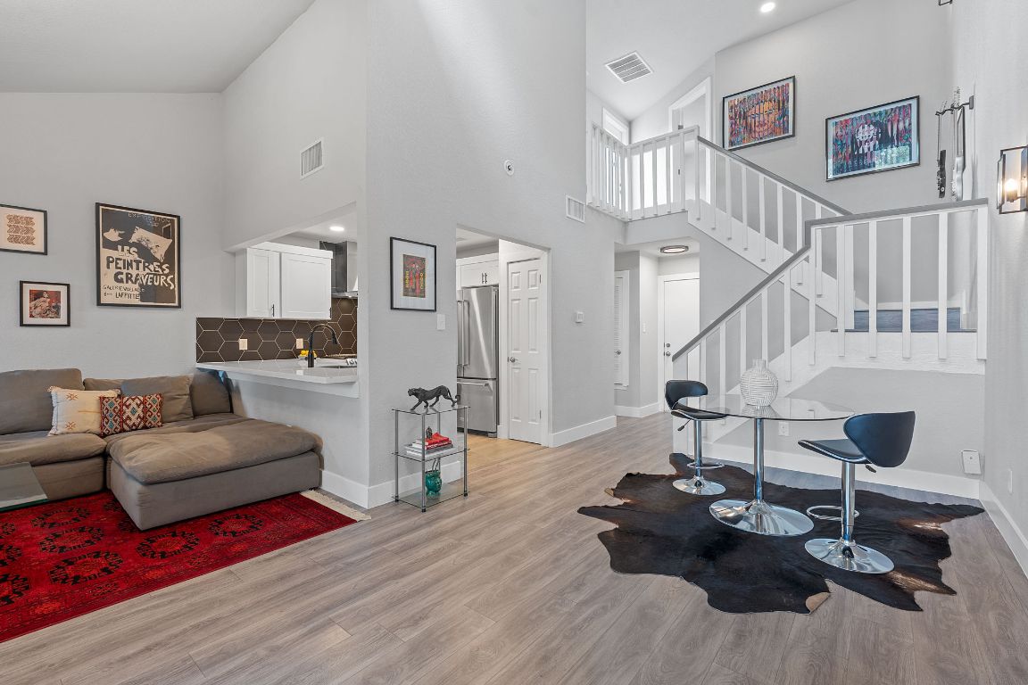 a living room with furniture and wooden floor