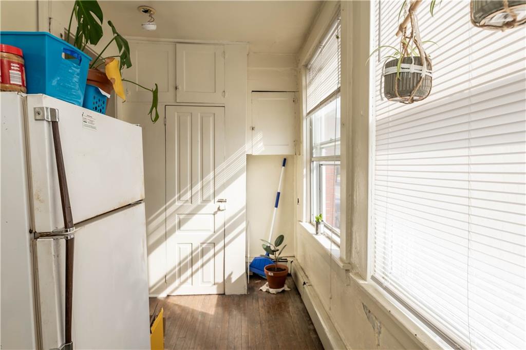 1071-1075 Philadelphia Street Indiana, PA 15701 - Photo 5 of 21 a view of a kitchen with wooden floor and electronic appliances