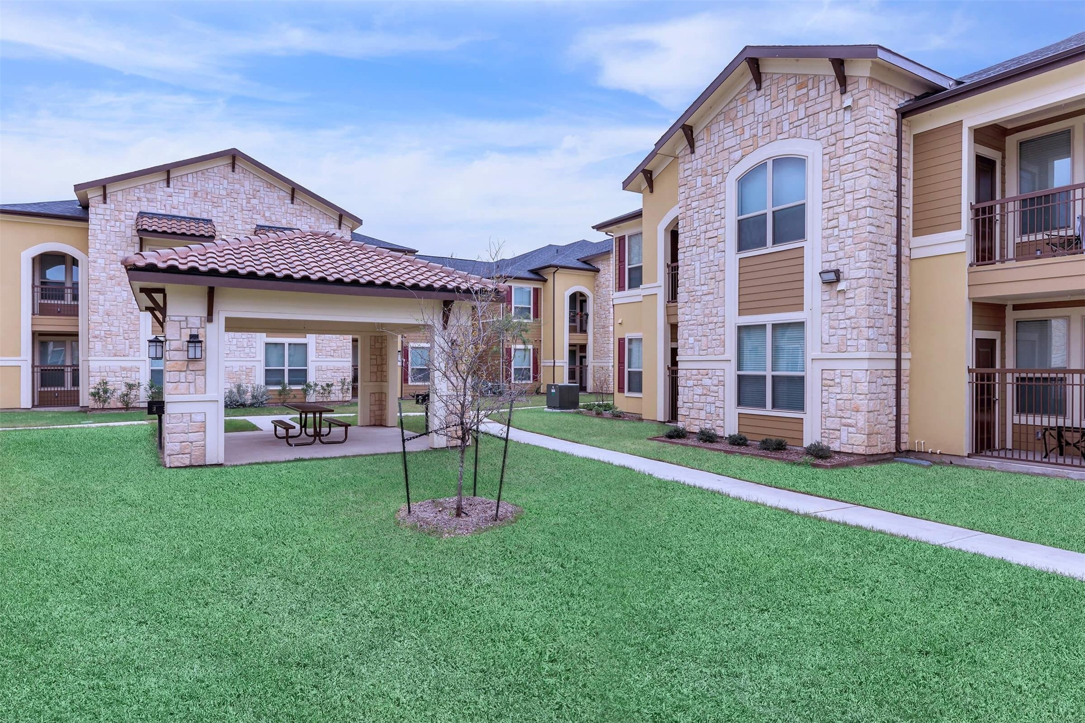 2601 South Border Avenue, Unit 132 Weslaco, TX 78596 - Photo 5 of 6 a front view of a house with a yard and porch