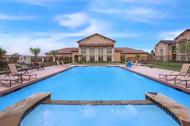a view of a swimming pool in front of residential houses