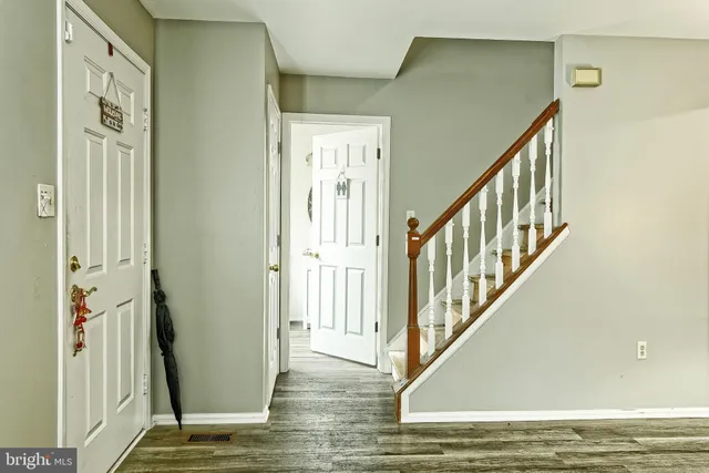 a view of an entryway with wooden floor