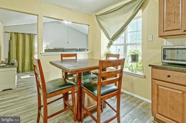 a dining room with furniture and wooden floor