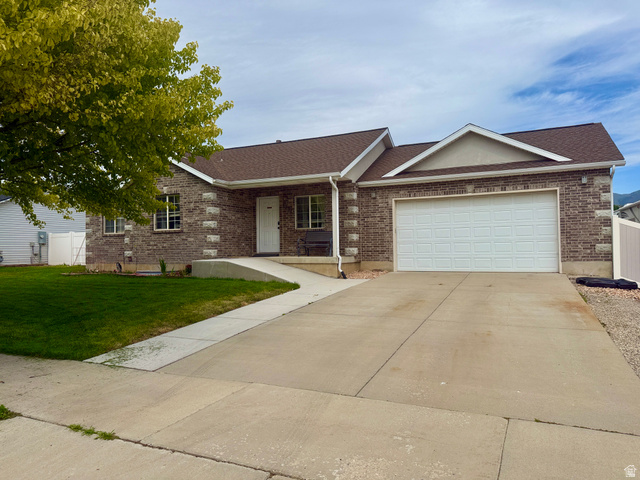 1353 360 West Payson, UT 84651 - Photo 1 of 16 Brick exterior featuring a gabled roofline and attached garage