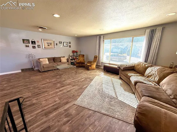 a living room with furniture and a large window