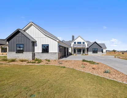 a view of empty room with wooden floor and fireplace
