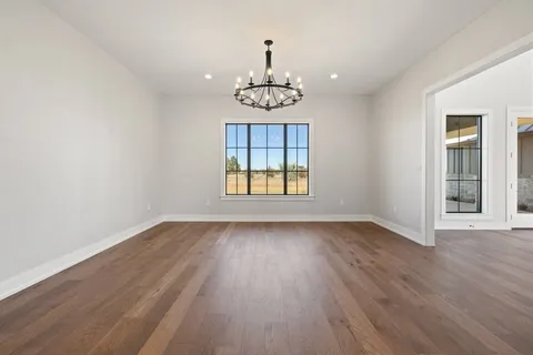 an open kitchen with wooden floor and window