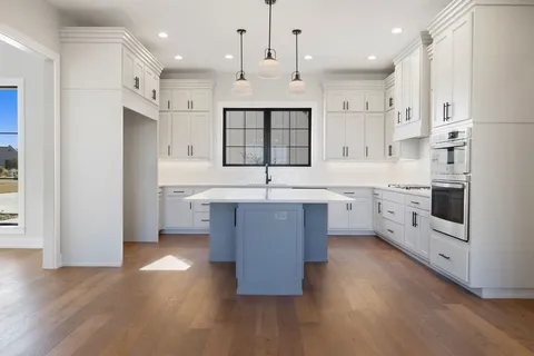 a kitchen with appliances cabinets and a sink