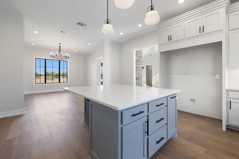 a kitchen with kitchen island white cabinets and white appliances