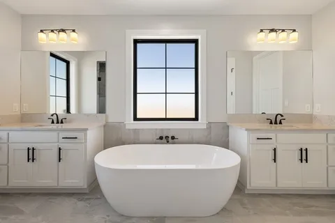 a view of an empty room with wooden floor and a fireplace