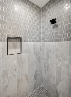 a spacious bathroom with a double vanity sink a mirror and a shower