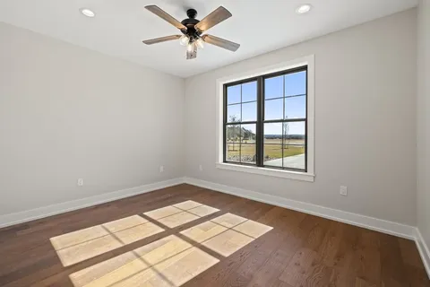 a kitchen with stainless steel appliances a stove a microwave and white cabinets