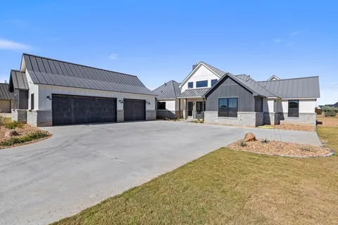a view of empty room with fireplace and wooden floor