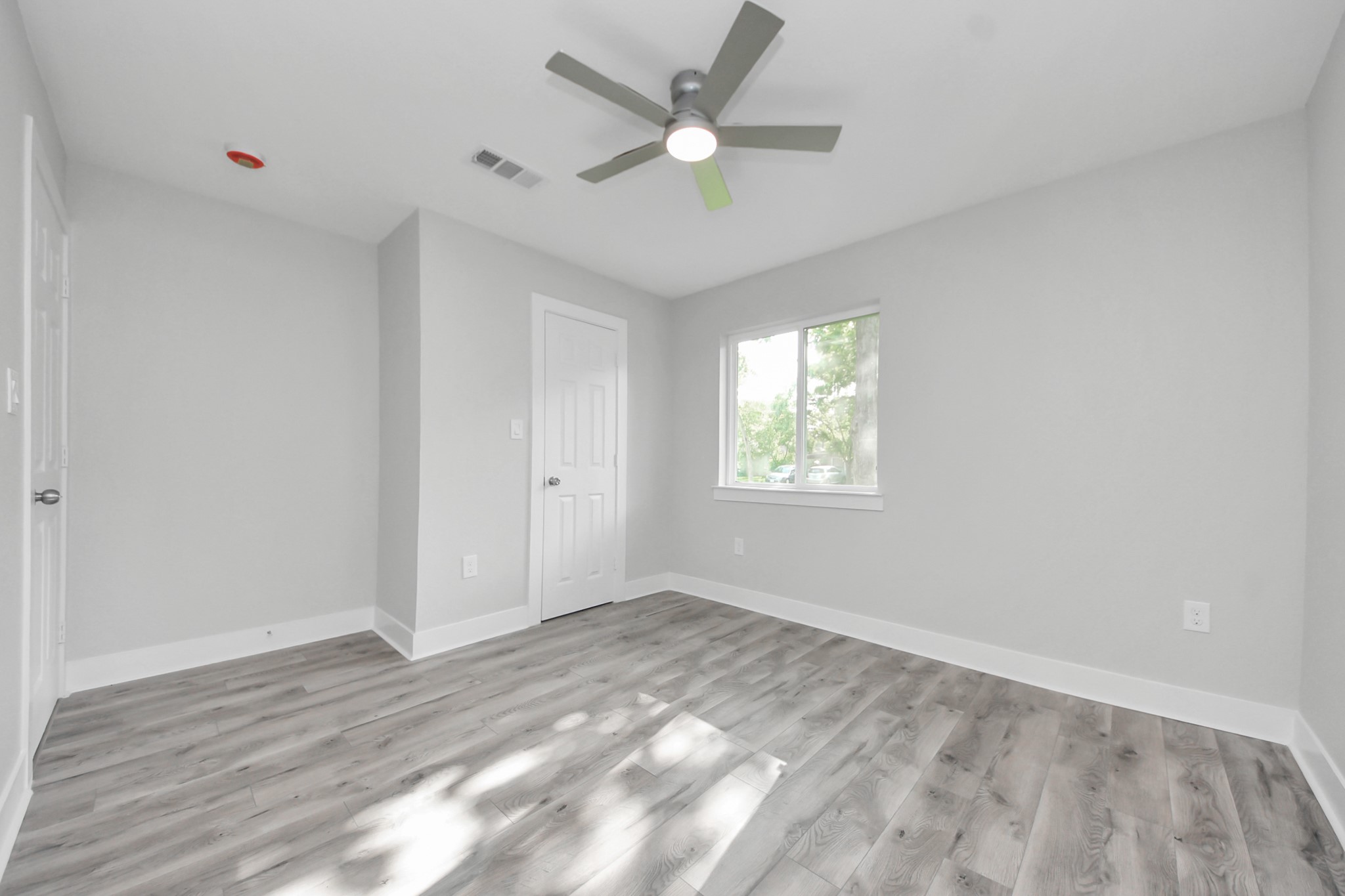 15318 Corsair Road Houston, TX 77053 - Photo 13 of 23 wooden floor in an empty room with a window