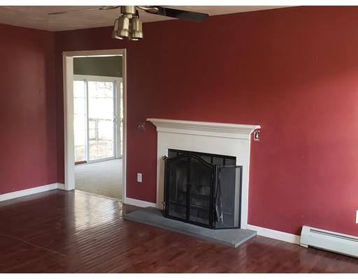 100 Haggerty Road Charlton, MA 01507 - Photo 6 of 22 a view of an empty room with wooden floor fireplace and a window