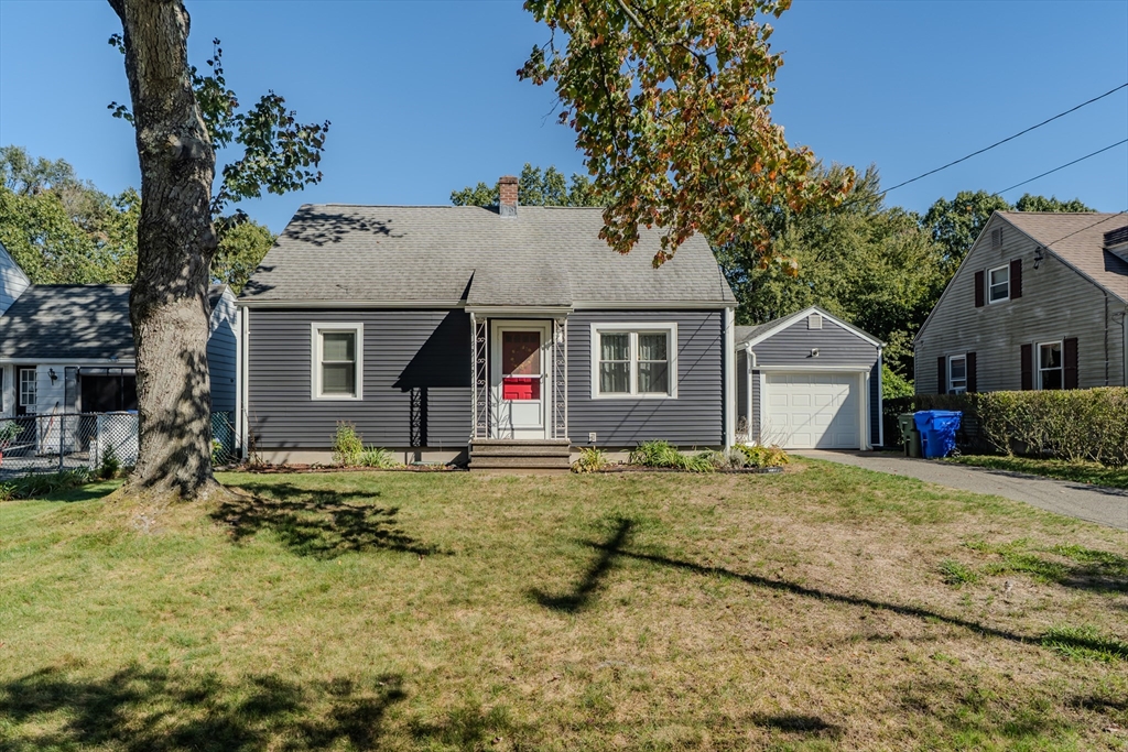 a view of a house with a yard and trees