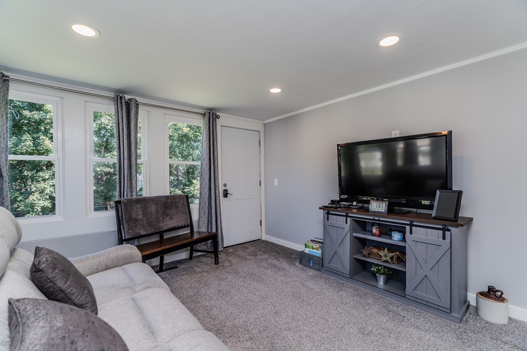 57 Lumae Street Springfield, MA 01119 - Photo 11 of 36 a living room with furniture and a flat screen tv