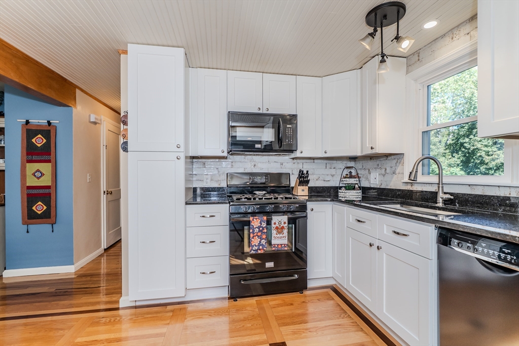 57 Lumae Street Springfield, MA 01119 - Photo 17 of 36 a kitchen with stainless steel appliances granite countertop a stove a sink and a refrigerator