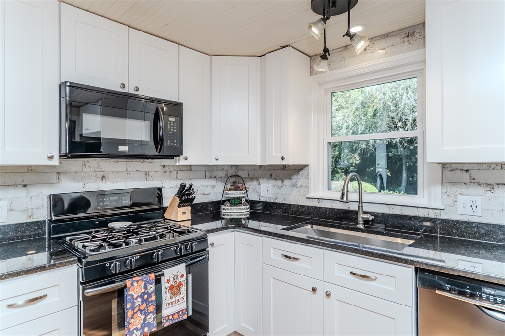 57 Lumae Street Springfield, MA 01119 - Photo 18 of 36 a kitchen with stainless steel appliances a stove a microwave and cabinets