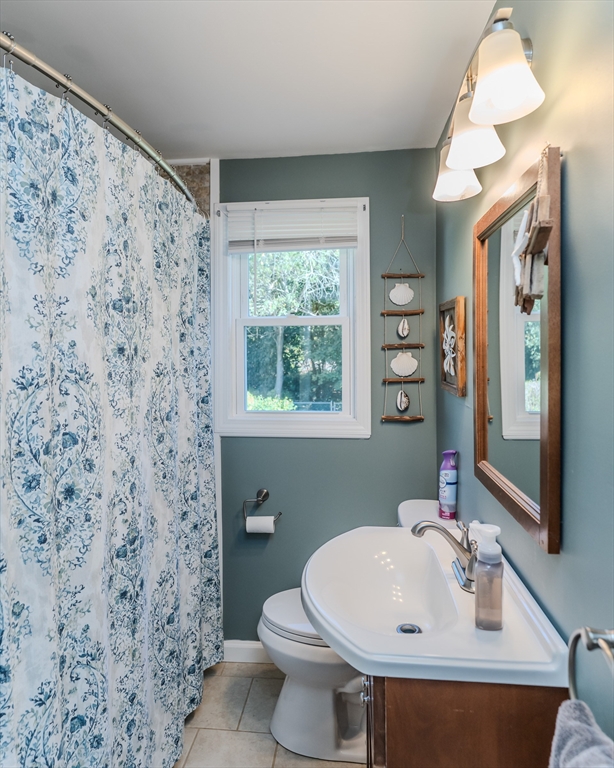 57 Lumae Street Springfield, MA 01119 - Photo 21 of 36 a bathroom with a sink a toilet and a mirror