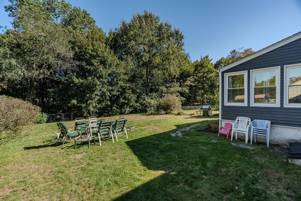 57 Lumae Street Springfield, MA 01119 - Photo 4 of 36 a view of a house with a backyard porch and sitting area