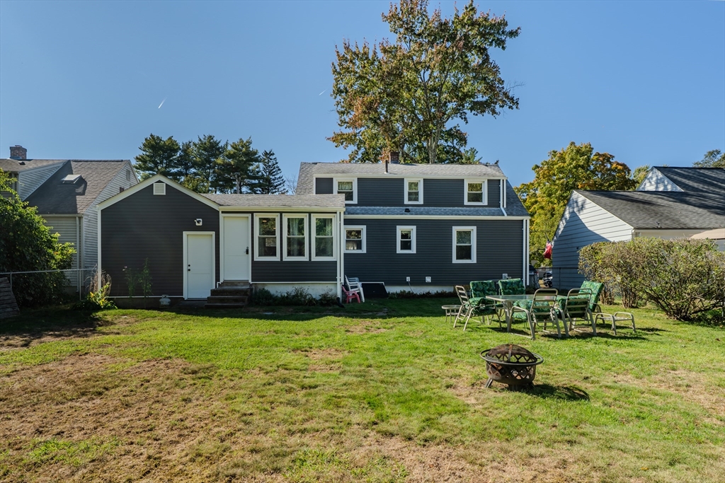 57 Lumae Street Springfield, MA 01119 - Photo 5 of 36 a front view of a house with a garden and trees