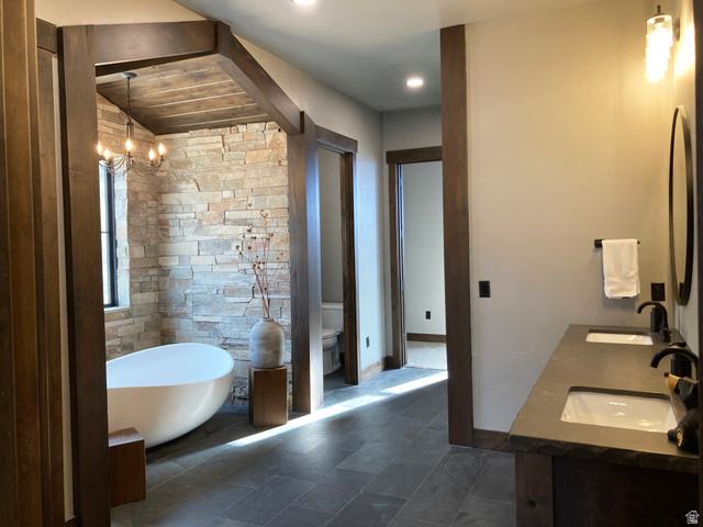 259 Meadow Drive Springville, UT 84663 - Photo 20 of 62 Full bathroom with double vanity, a soaking tub, and hanging lights