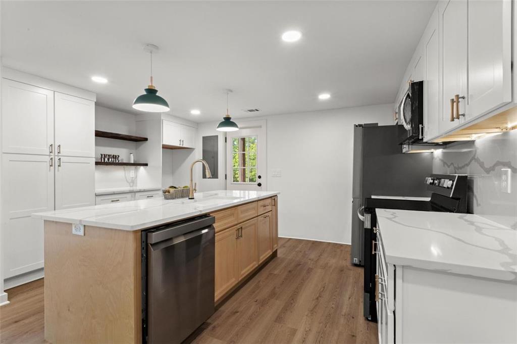 505 Cedar Creek Road Cartersville, GA 30121 - Photo 13 of 32 a kitchen with a sink a center island stainless steel appliances and cabinets