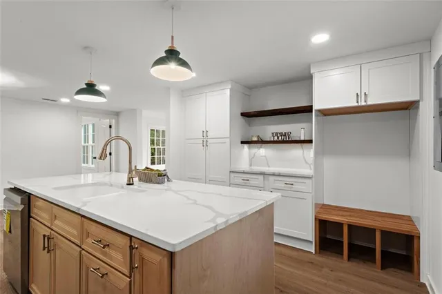 a kitchen with stainless steel appliances a sink a stove a refrigerator and cabinets