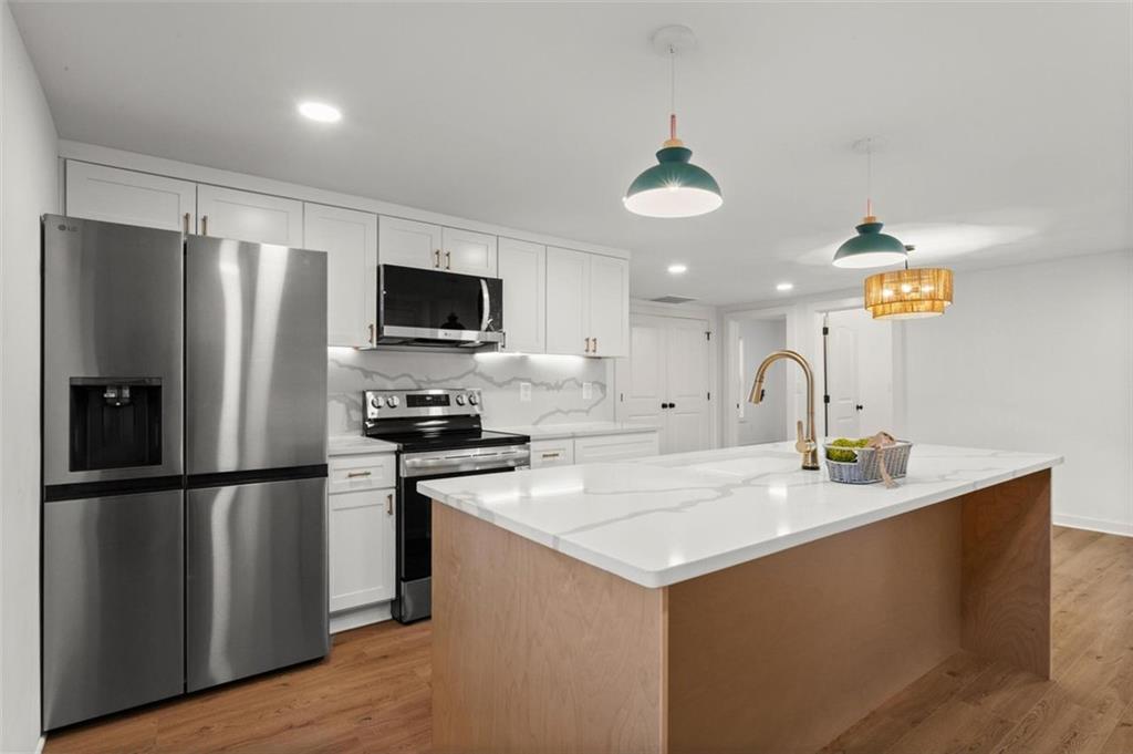 505 Cedar Creek Road Cartersville, GA 30121 - Photo 15 of 32 a kitchen with stainless steel appliances granite countertop a refrigerator a sink and a stove