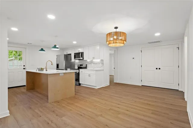 a view of kitchen with wooden floor and window