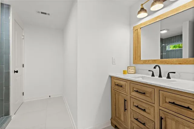 a bathroom with a sink vanity and mirror