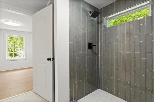a bathroom with a shower and a window