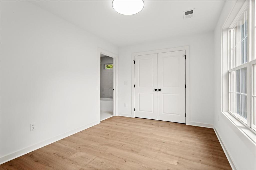 505 Cedar Creek Road Cartersville, GA 30121 - Photo 25 of 32 a view of an empty room with wooden floor and a window