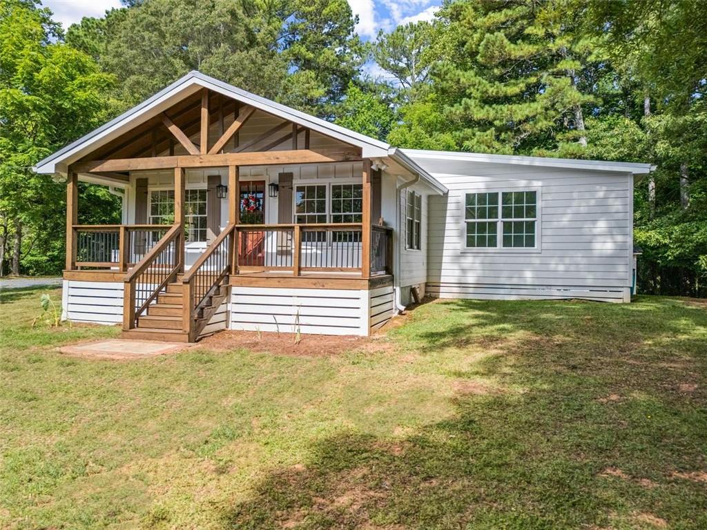 505 Cedar Creek Road Cartersville, GA 30121 - Photo 4 of 32 a view of a house with a yard and lawn chairs