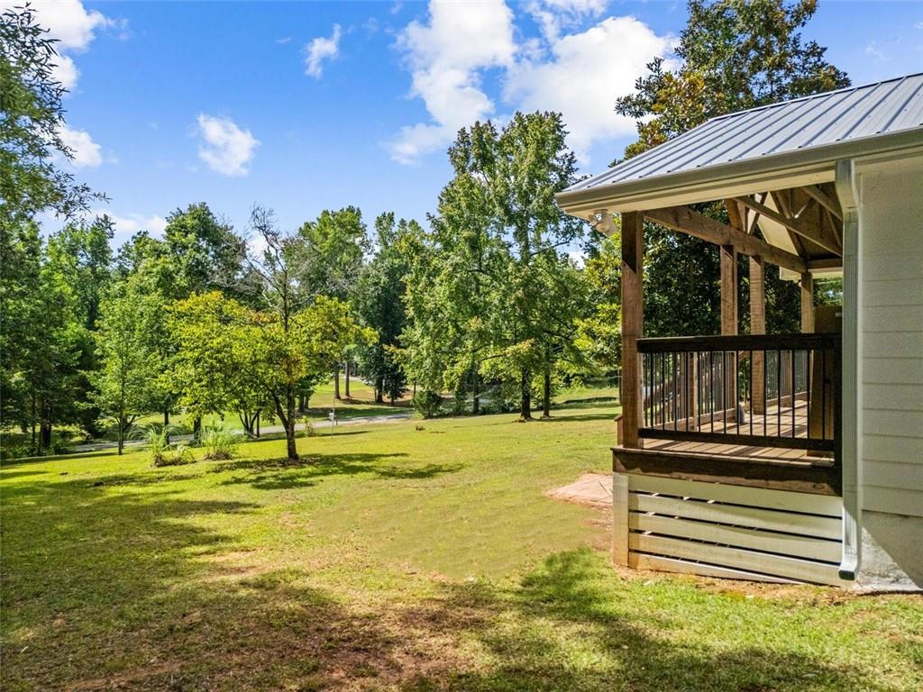 505 Cedar Creek Road Cartersville, GA 30121 - Photo 5 of 32 a view of a swimming pool with an outdoor space and seating area
