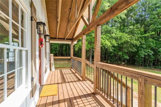 a view of balcony with wooden floor and fence