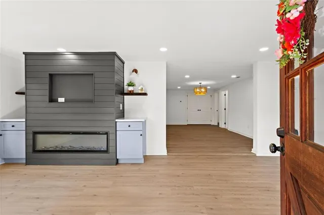 a view of an empty room and kitchen