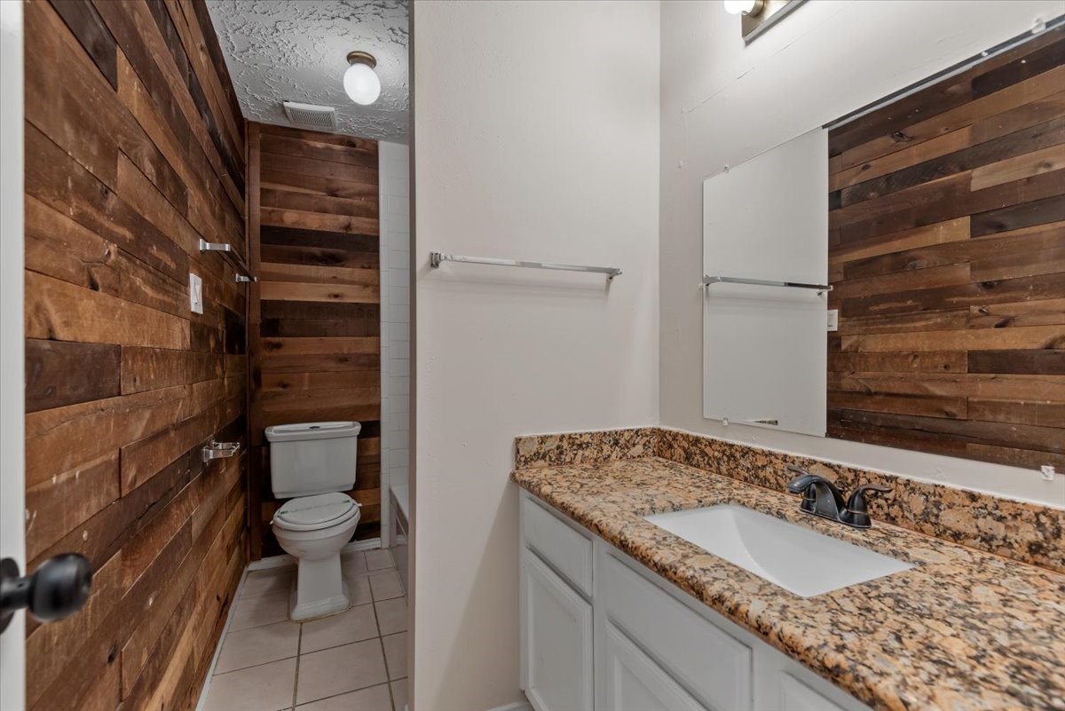 6022 Sean Court Humble, TX 77346 - Photo 14 of 18 a bathroom with a granite countertop sink and a mirror