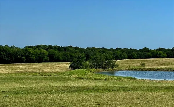 a view of a green field with an outdoor space