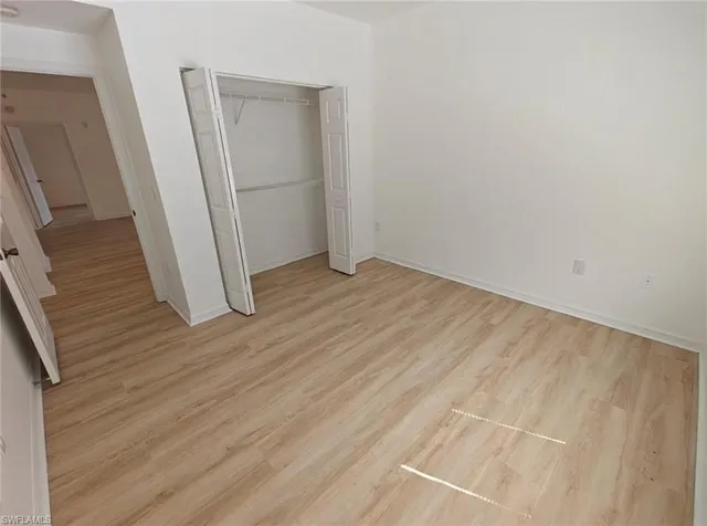 an empty room with wooden floor