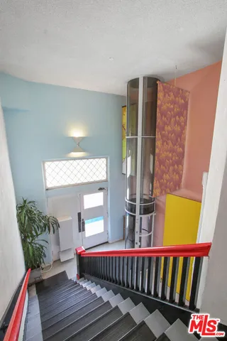a living room with a couch and a potted plant