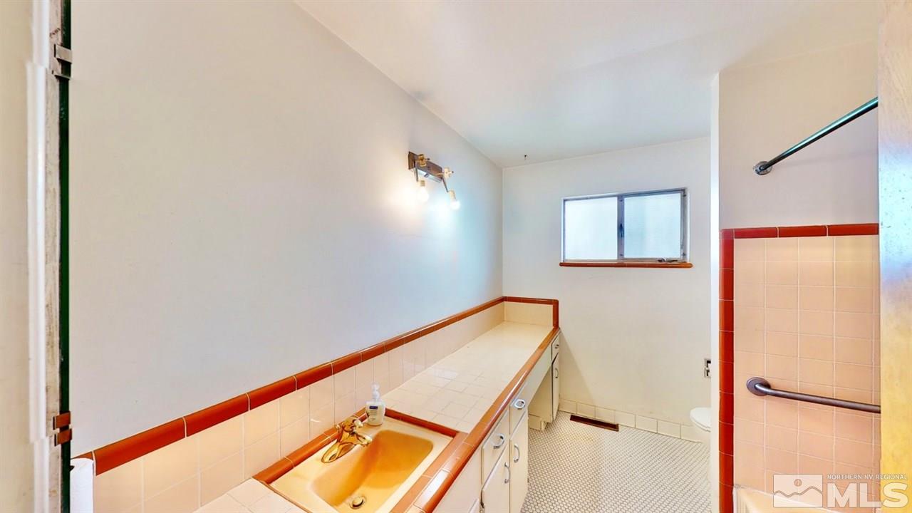 795 Thoma Street Reno, NV 89502 - Photo 14 of 40 a view of a room with wooden floor and a window